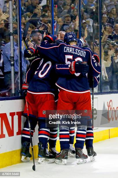 Markus Nutivaara of the Columbus Blue Jackets is congratulated by his teammates after scoring a goal during the second period in Game Four of the...