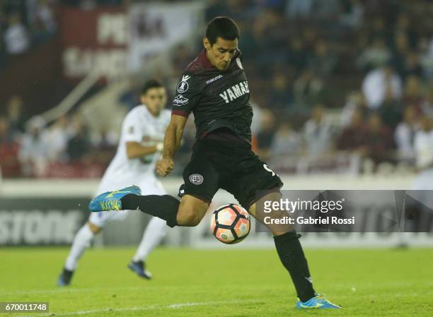 Jose Sand of Lanus kicks the ball to score the second goal of his team during a group stage match between Lanus and Zulia as part of Copa CONMEBOL...