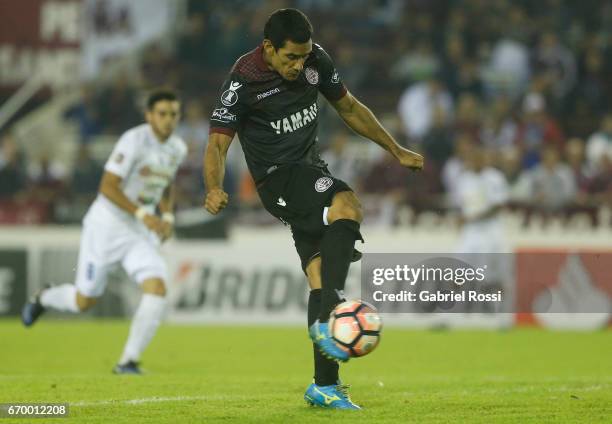 Jose Sand of Lanus kicks the ball to score the second goal of his team during a group stage match between Lanus and Zulia as part of Copa CONMEBOL...