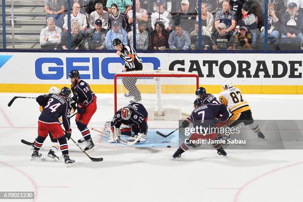 Goaltender Sergei Bobrovsky of the Columbus Blue Jackets defends the net as William Karlsson of the Columbus Blue Jackets and Sidney Crosby of the...