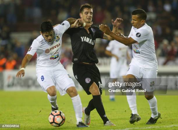 Alejandro Silva of Lanus fights for the ball with Junior Moreno of Zulia during a group stage match between Lanus and Zulia as part of Copa CONMEBOL...