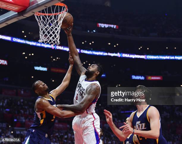 DeAndre Jordan of the LA Clippers preparres to dunk on Rodney Hood and Jeff Withey of the Utah Jazz during the first half in Game Two of the Western...