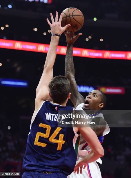 Jamal Crawford of the LA Clippers scores on a jump hook over Jeff Withey of the Utah Jazz during the first half in Game Two of the Western Conference...