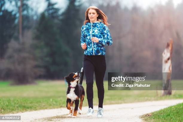 young woman jogging with dog - puppy running stock pictures, royalty-free photos & images