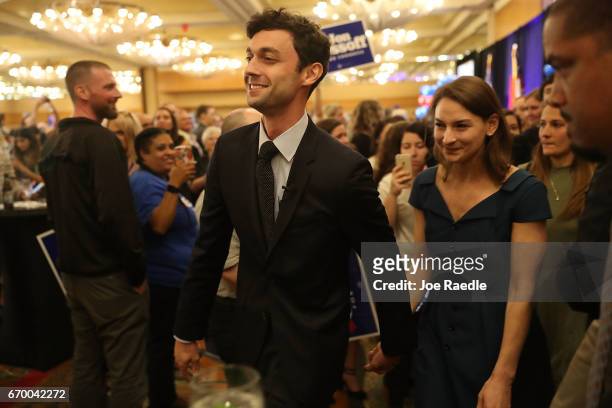 Democratic candidate Jon Ossoff walks with his girlfriend Alisha Kramer after speaking to his supporters as votes continue to be counted in a race...