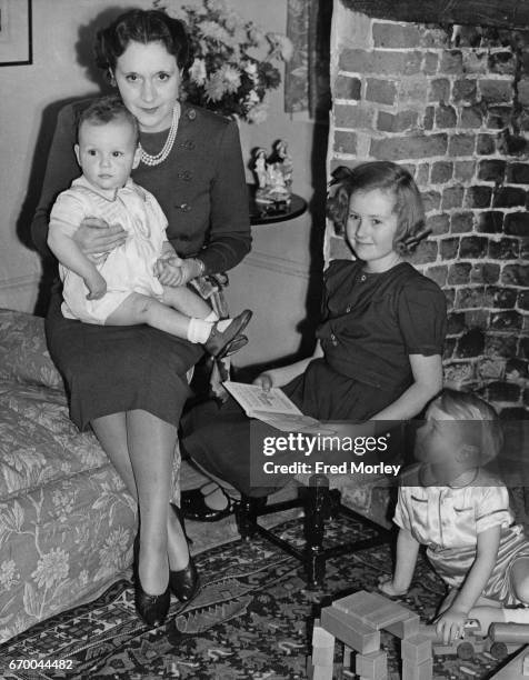 Novelist Barbara Cartland with her three children, Glen, Raine and Ian, 16th December 1940. They have returned from Canada and are living in...