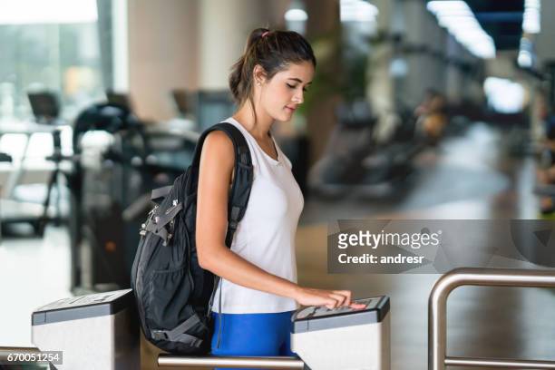 woman getting a fingerprint scan to access the gym - entering stock pictures, royalty-free photos & images