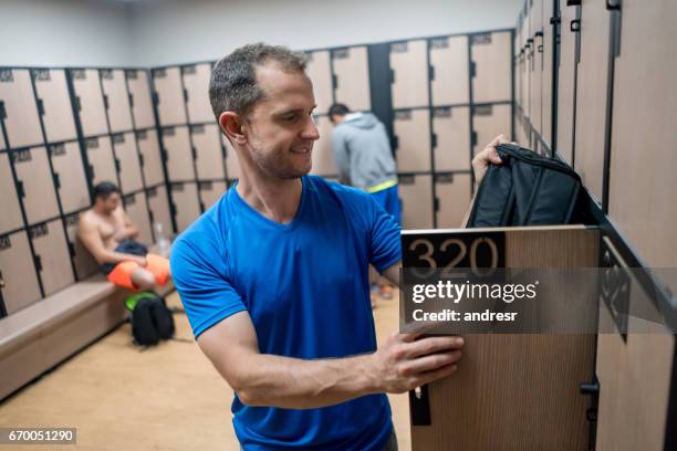 man at the gym changing in the locker room - mens changing room stock pictures, royalty-free photos & images