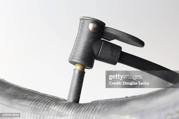 portable hand pump inflates a tire tube - anatomical valve stock pictures, royalty-free photos & images