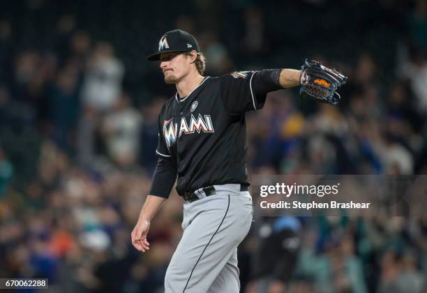 Starting pitcher Tom Koehler of the Miami Marlins reacts after giving up a home run to Nelson Cruz of the Seattle Mariners during the first inning of...