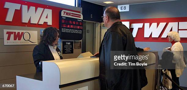 Passenger bound for St. Louis, MO checks in at the Trans World Airlines gate for a ticket agent January 8, 2001 at Chicago's O''Hare International...