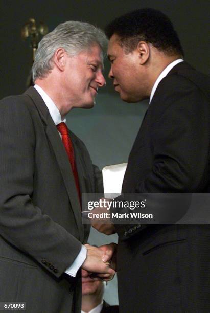 President Bill Clinton gives Muhammad Ali the Presidential Citizens Medal award January 8, 2001 at the White House in Washiongton, DC. The...