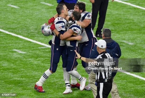 Tom Brady, Julian Edelman and David Andrews of the New England Patriots celebrates after they scored the winning touchdown against the Atlanta...