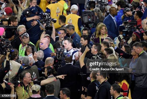 Tom Brady of the New England Patriots gets surrounded by photographers and media after the Patriots defeat the Atlanta Falcons 34-28 in overtime of...