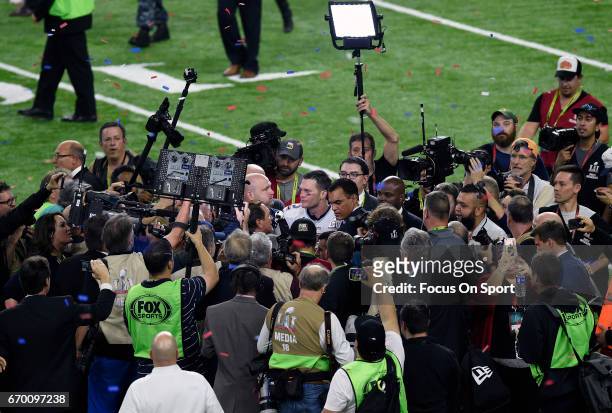 Tom Brady of the New England Patriots gets surrounded by photographers and media after the Patriots defeat the Atlanta Falcons 34-28 in overtime of...