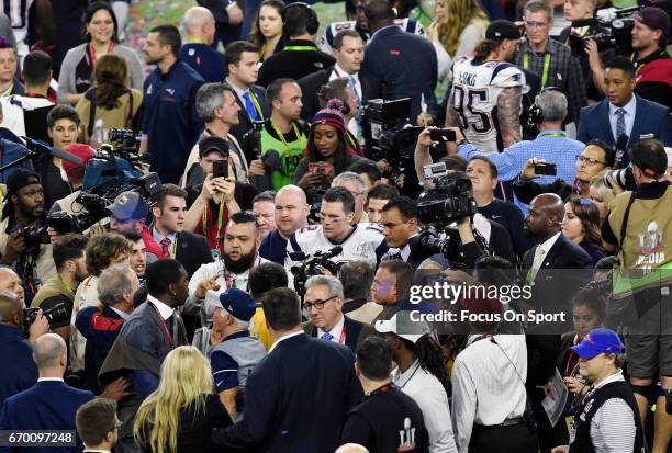 Tom Brady of the New England Patriots gets surrounded by photographers and media after the Patriots defeat the Atlanta Falcons 34-28 in overtime of...