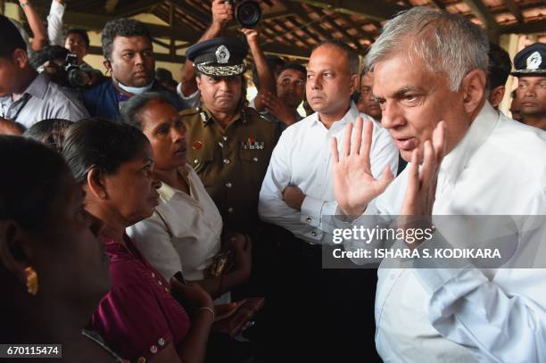 Sri Lanka's Prime Minister Ranil Wickremesinghe meets with survivors and displaced people at a relief camp after a massive garbage mountain collapse...