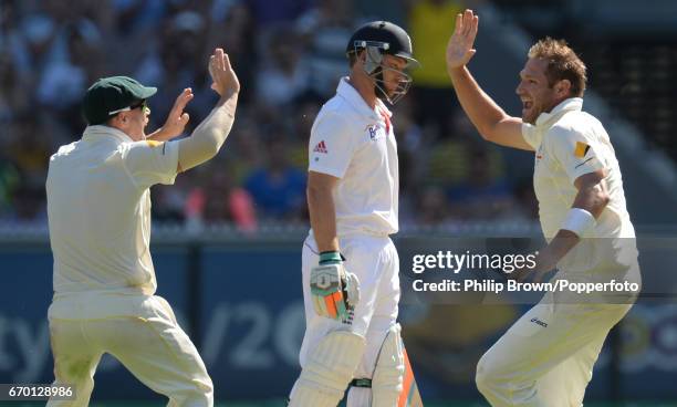 Australia's David Warner & Ryan Harris celebrate after the dismissal of England's Ian Bell on the first day of the 4th Ashes cricket Test match...