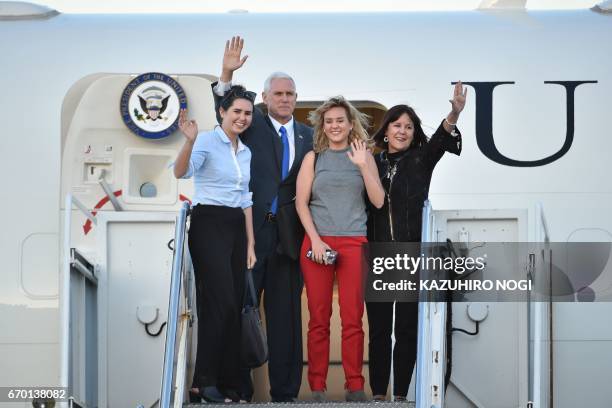 Vice President Mike Pence , his wife Karen , and their two daughters Audrey and Charlotte wave as they depart Japan from the US naval air facility in...