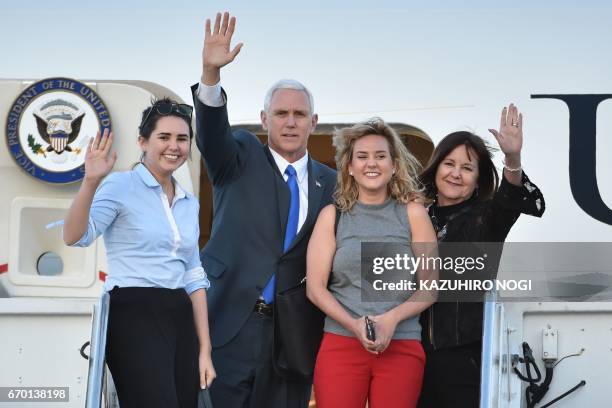 Vice President Mike Pence , his wife Karen , and their two daughters Audrey and Charlotte wave as they depart Japan from the US naval air facility in...