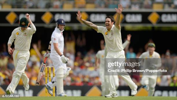 Australia's Mitchell Johnson celebrates after dismissing England's Graeme Swann during the 1st Ashes cricket Test match between Australia and England...