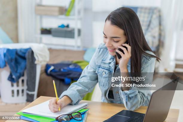 college girl works on homework in dorm room - dorm room stock pictures, royalty-free photos & images