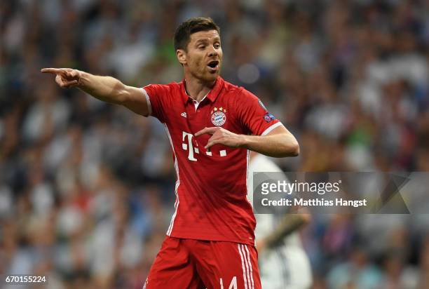 Xavi Alonso of FC Bayern Muenchen gestures during the UEFA Champions League Quarter Final second leg match between Real Madrid CF and FC Bayern...