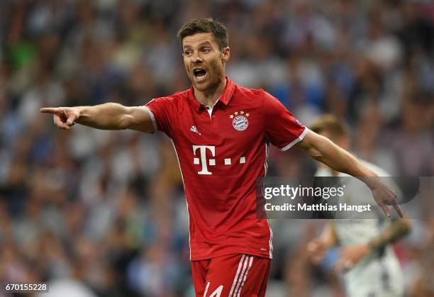 Xavi Alonso of FC Bayern Muenchen gestures during the UEFA Champions League Quarter Final second leg match between Real Madrid CF and FC Bayern...