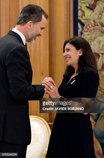King Felipe VI of Spain cheers mayor of Paris, Anne Hidalgo during their meeting at La Zarzuela Palace in Madrid on April 19, 2017.