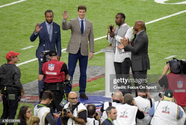 The Walter Payton Man of the Year recipient Larry Fitzgerald and Eli Manning stands with the 2016 winner Anquan Boldin prior to the start of Super...