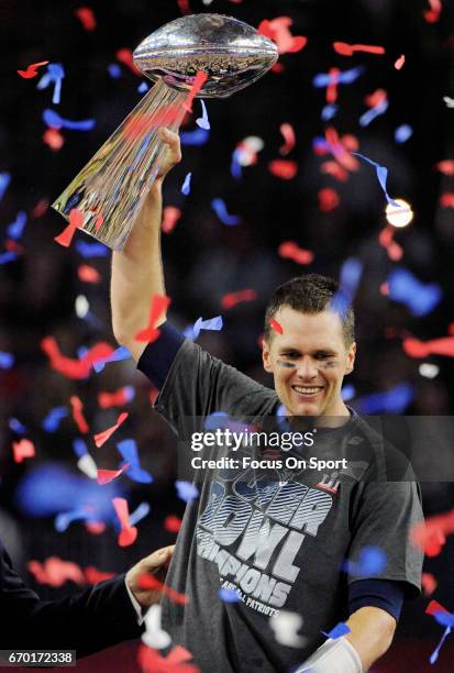 Tom Brady of the New England Patriots raises the Vince Lombardi trophy after the Patriots defeat the Atlanta Falcons 34-28 in overtime of Super Bowl...