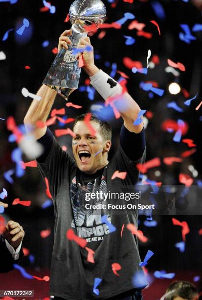 Tom Brady of the New England Patriots raises the Vince Lombardi trophy after the Patriots defeat the Atlanta Falcons 34-28 in overtime of Super Bowl...