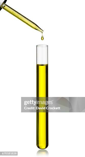 oil dripping into test tube - test tube stock-fotos und bilder