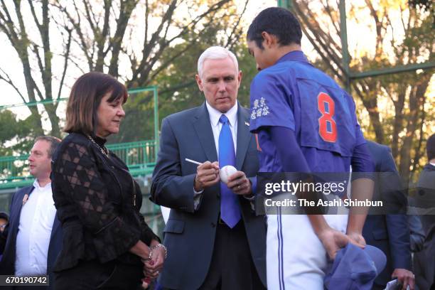 Vice President Mike Pence signs auntographs for a participant while his wife Karen Pence watches during a youth baseball and softball clinic on April...