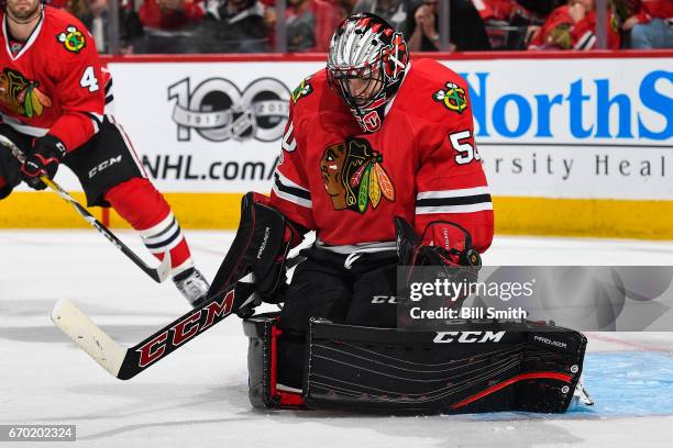 The puck deflects off of goalie Corey Crawford of the Chicago Blackhawks in the second period against the Nashville Predators in Game One of the...