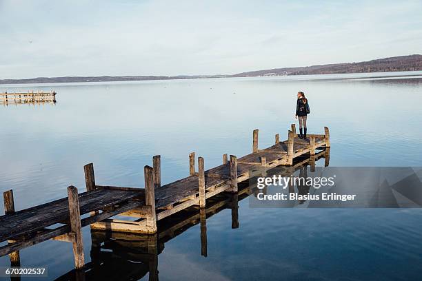 young woman on a jetty - dießen stock-fotos und bilder