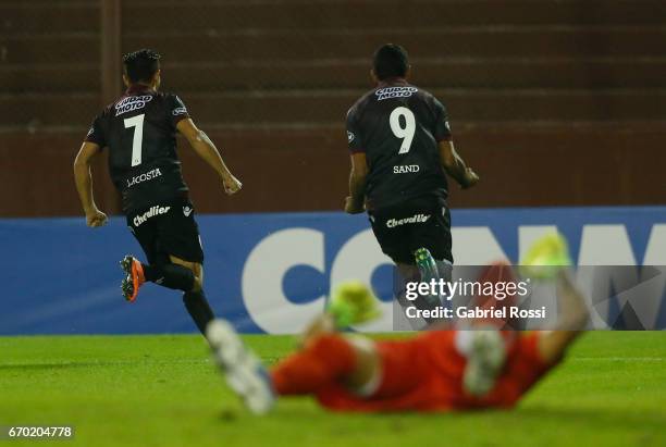 Jose Sand of Lanus celebrates with teammate Lautaro Acosta after scoring the second goal of his team during a group stage match between Lanus and...