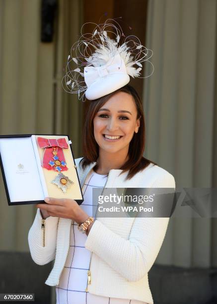 Jessica Ennis-Hill poses with her award after she was made a Dame CBE by the Duke of Cambridge during an investiture ceremony at Buckingham Palace on...