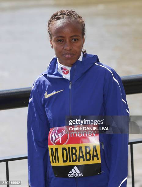 Ethiopia's Mare Dibaba poses outside Tower Bridge in central London during a photocall for the Women's marathon elite athletes on April 19, 2017...