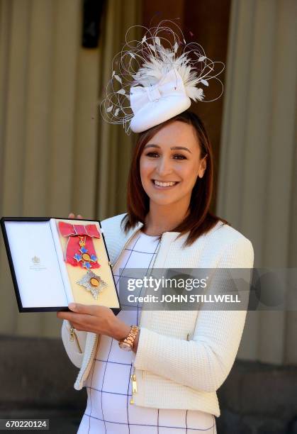 Former British track and field athlete, Jessica Ennis-Hill holds her award after she was made a Dame Commander of the Order of the British Empire for...