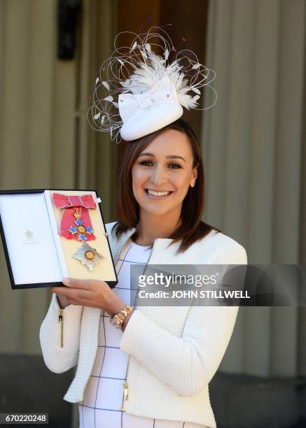 Former British track and field athlete, Jessica Ennis-Hill holds her award after she was made a Dame Commander of the Order of the British Empire for...
