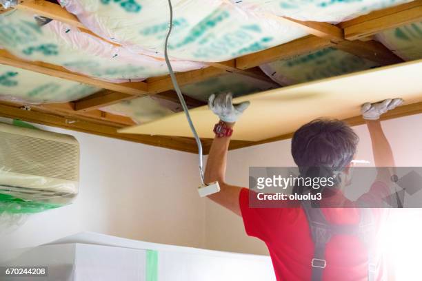professional carpenter is fixing the ceiling - insulation stock pictures, royalty-free photos & images