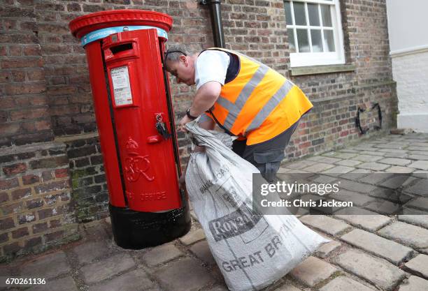 Postman empties the Kensington Palace post-box, with the Heads Together headband on it, placed there by Catherine, Duchess of Cambridge in support of...