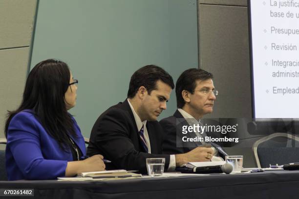 Ricardo Rosello, governor of Puerto Rico, sits between Itza Garcia, associate chief of staff for Rossello, left, and Luis Gerardo Rivera, Puerto...