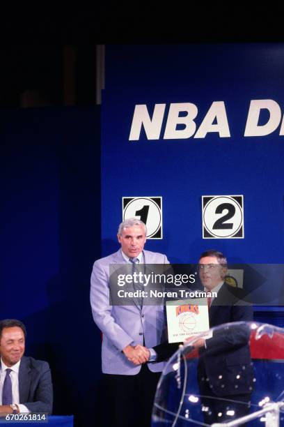 Commissioner David Stern and Dave DeBusschere of the New York Knicks pose for a photo after the Knicks won the First overall pick during the 1985 NBA...