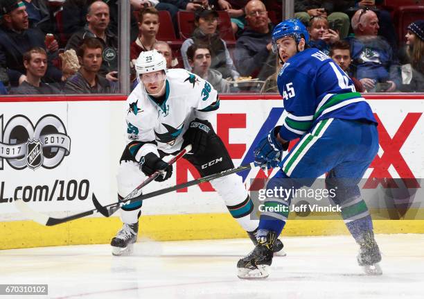 April 2: Michael Chaput of the Vancouver Canucks and Jannik Hansen of the San Jose Sharks watch a loose puck during their NHL game at Rogers Arena...