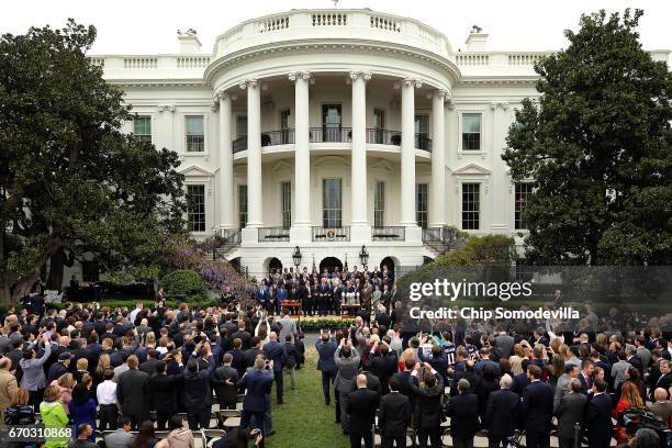 President Donald Trump poses for photographs with the New England Patriots during a celebration of the team's Super Bowl victory on the South Lawn at...