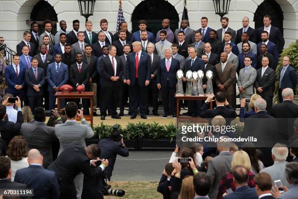 President Donald Trump poses for photographs with the New England Patriots during a celebration of the team's Super Bowl victory on the South Lawn at...