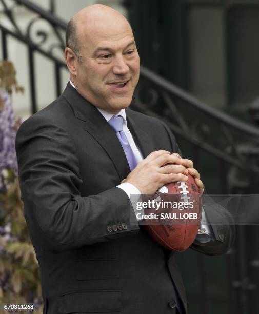 Gary Cohn, director of the National Economic Council, holds a football after US President Donald Trump honored the New England Patriots as 2017 Super...