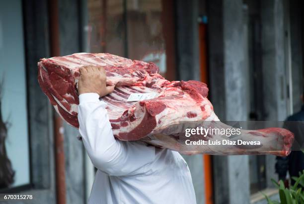 person carrying meat to a butchers' shop - carcass meat stock pictures, royalty-free photos & images